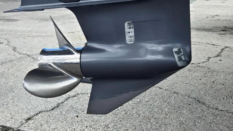 Slide: The Image of Close-up of a shiny propeller on a gray outboard motor. - 25