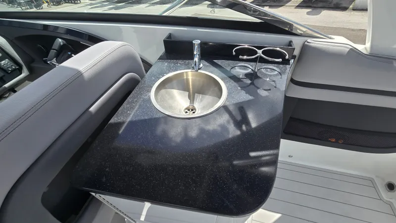 Slide: The Image of A sleek sink with a black countertop on a Cobalt 30SC boat. - 8