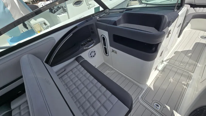 Slide: The Image of The image shows the cockpit of a 2023 Cobalt 30SC boat with gray upholstery and modern details. - 6