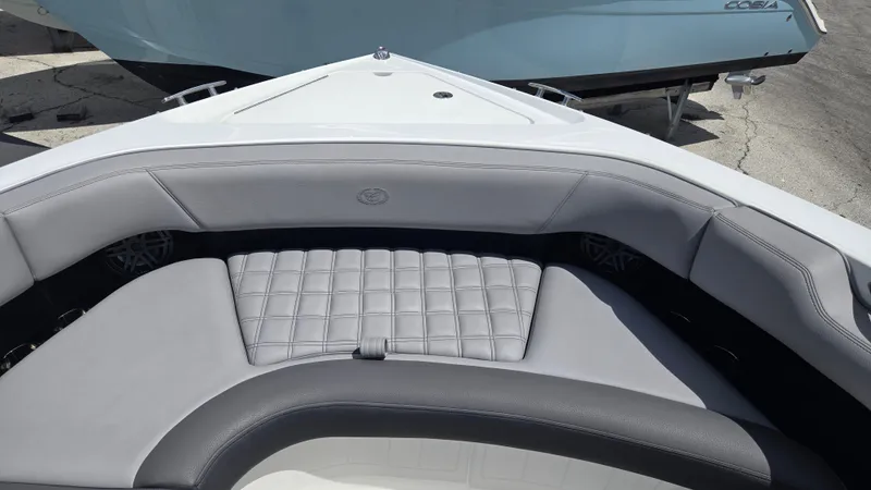 Slide: The Image of The image shows the bow area of a Cobalt 30SC boat with gray upholstery and speakers. - 13