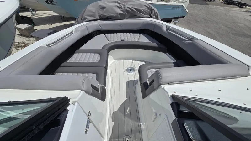 Slide: The Image of The image shows the bow area of a 2023 Cobalt 30SC boat with cushioned seating. - 14