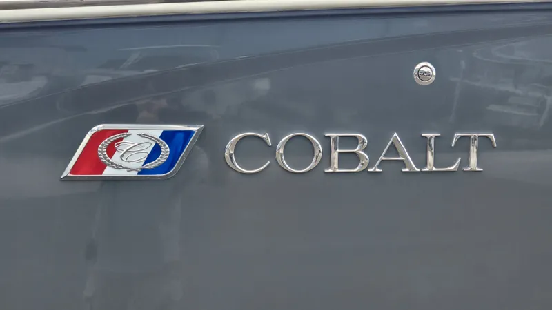 Slide: The Image of Close-up of the Cobalt logo on a gray boat hull. - 18