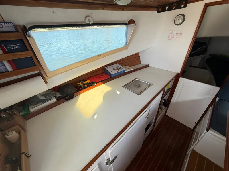 Slide: The Image of Interior of a 1959 Dyer 29 Trunk Cabin with a countertop and window. - 28