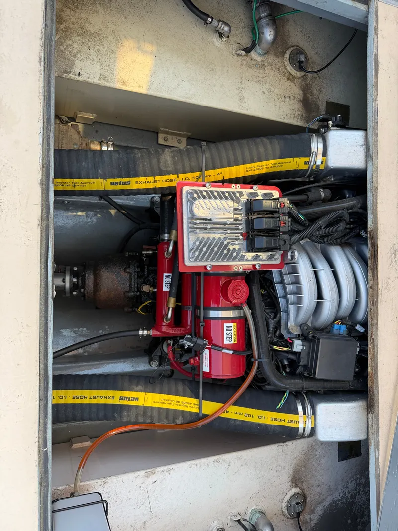 Slide: The Image of The engine compartment of a 1959 Dyer 29 Trunk Cabin shows a well-maintained engine. - 23
