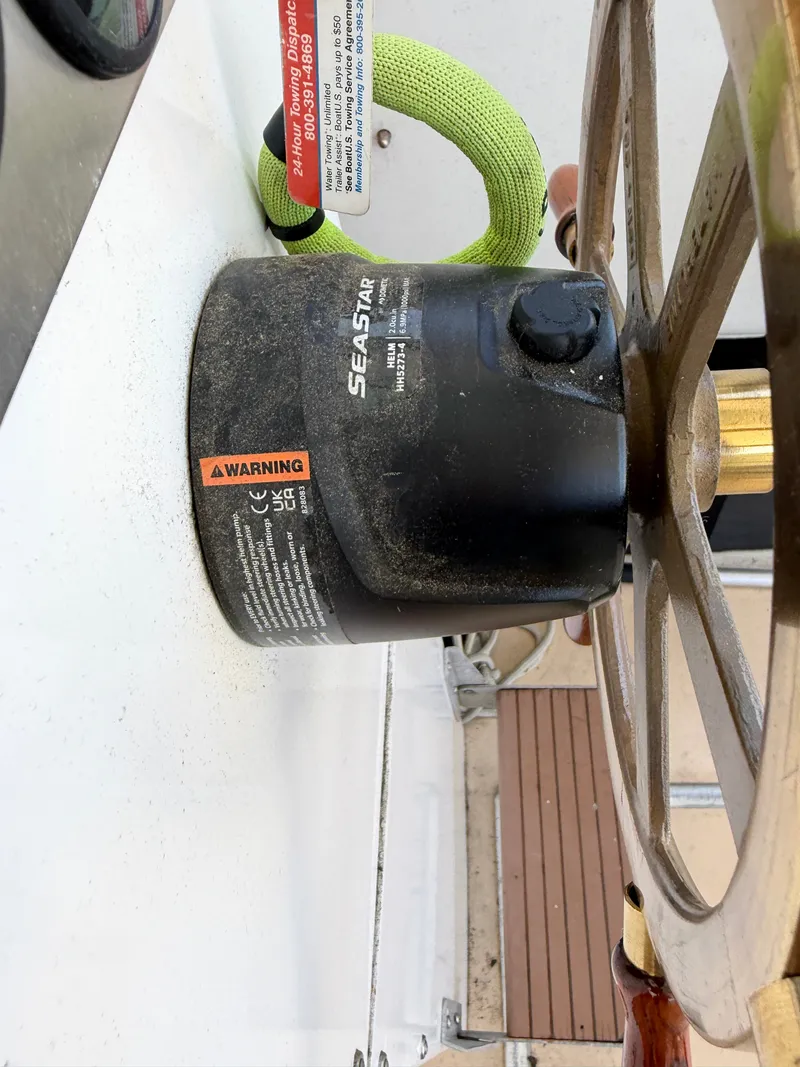 Slide: The Image of Close-up of a steering wheel with a SeaStar hydraulic system in a Dyer 29 Trunk Cabin boat. - 16