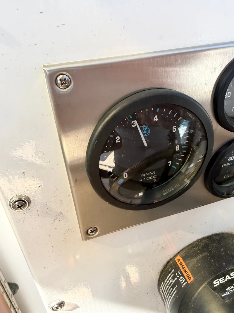 Slide: The Image of Close-up of a tachometer on a boat, showing 1000 RPM. - 42
