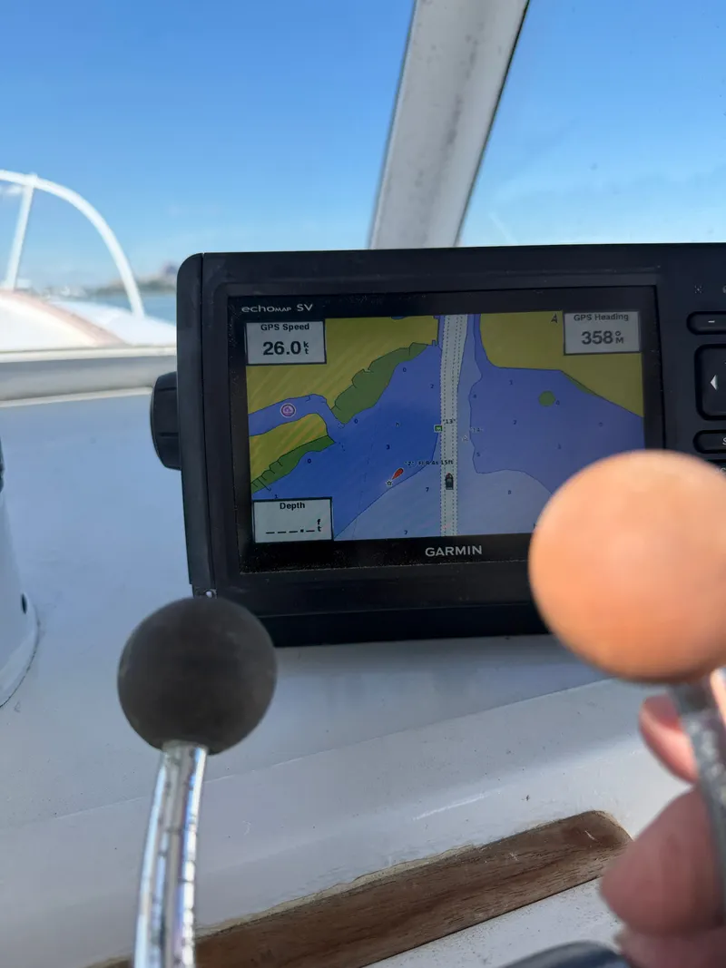 Slide: The Image of A Garmin navigation system displays a map with GPS speed. Two control levers are visible. - 48