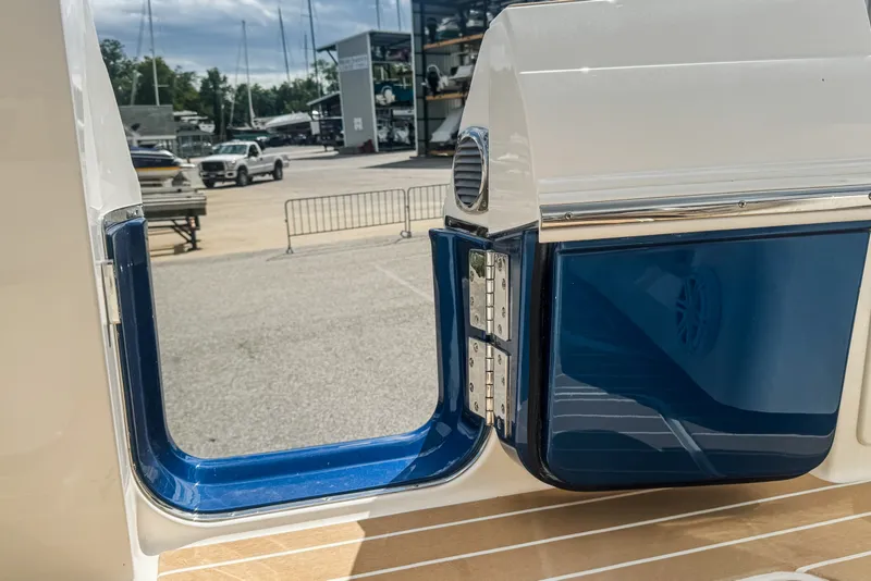 Slide: The Image of 2027 Tiara Yachts 39 LS boat detail with blue and white accents at a marina. - 37