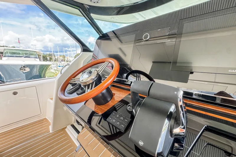 Slide: The Image of 2027 Tiara Yachts 39 LS helm with wooden steering wheel and modern controls. - 25