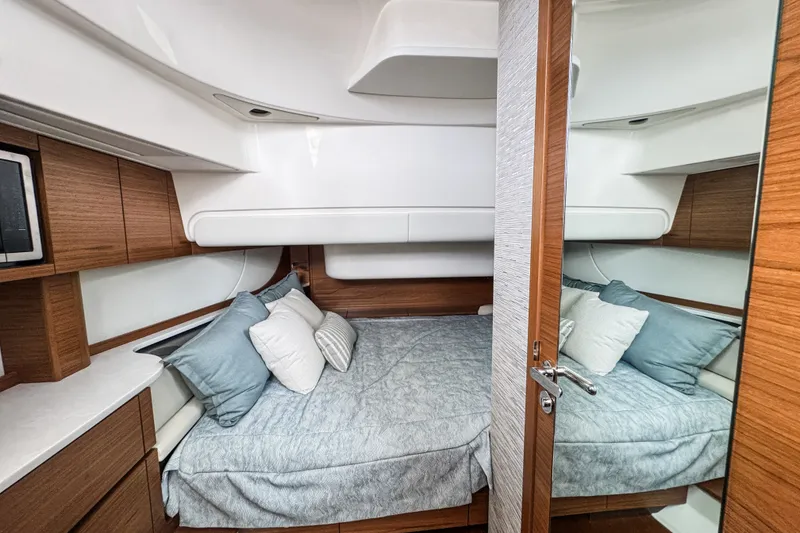Slide: The Image of Luxurious cabin interior of 2027 Tiara Yachts 39 LS with cozy bedding and wooden accents. - 39