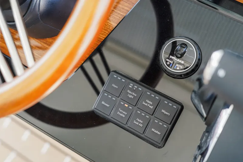 Slide: The Image of Dashboard controls of 2027 Tiara Yachts 39 LS, featuring steering wheel and control panel. - 17
