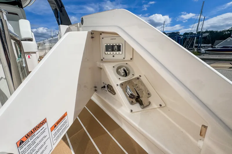 Slide: The Image of 2027 Tiara Yachts 39 LS deck detail with control panel and warning labels. - 38