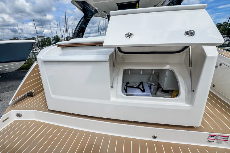 Slide: The Image of 2027 Tiara Yachts 39 LS storage compartment on deck, open with visible contents. - 28