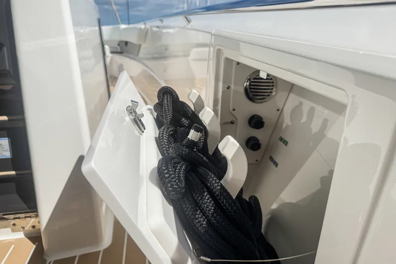 Slide: The Image of Storage compartment on 2027 Tiara Yachts 39 LS, featuring coiled black ropes. - 35