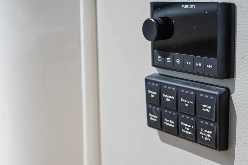 Slide: The Image of Control panel on 2027 Tiara Yachts 39 LS, featuring audio and lighting switches. - 16