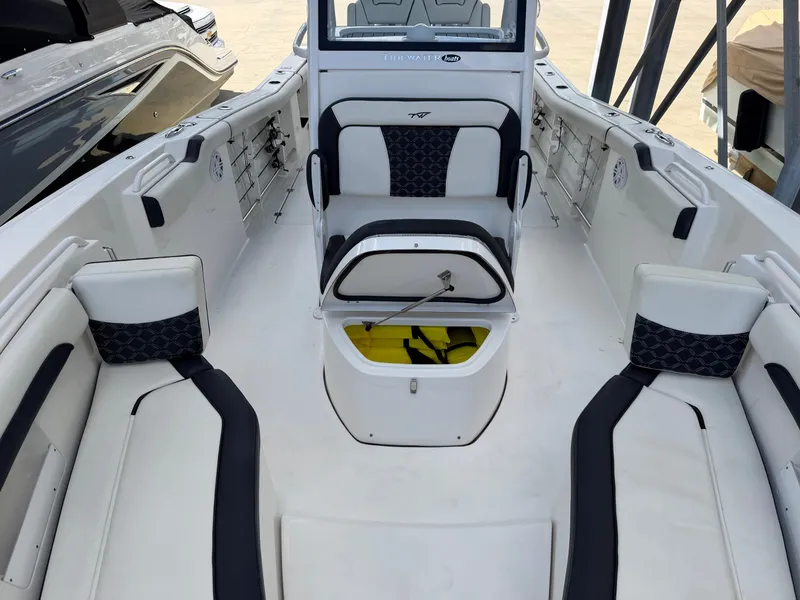 Slide: The Image of The image shows the cockpit of a 2021 Tidewater 272 CC Adventure boat with seating and storage. - 42