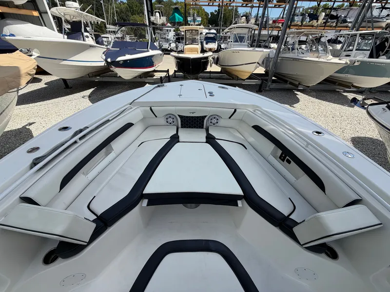 Slide: The Image of The image shows the bow area of a 2021 Tidewater 272 CC Adventure boat with white upholstery. - 45