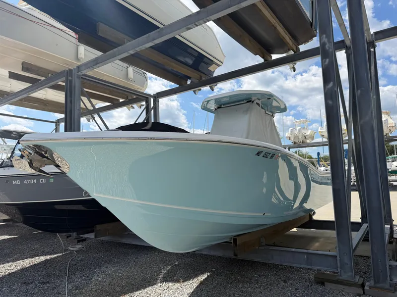 The Image of A 2021 Tidewater 272 CC Adventure boat is on a rack in a marina. - 0