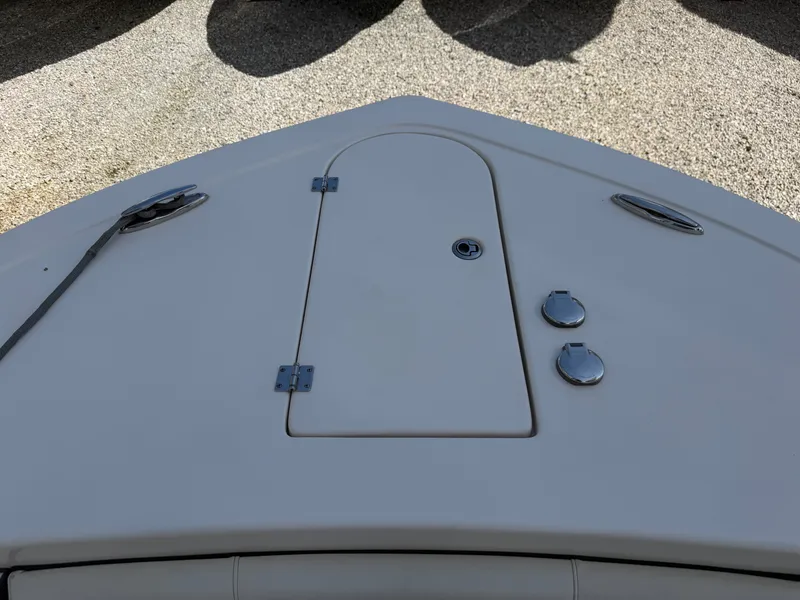 Slide: The Image of The front of a boat with a hatch and two round covers on the deck. - 36