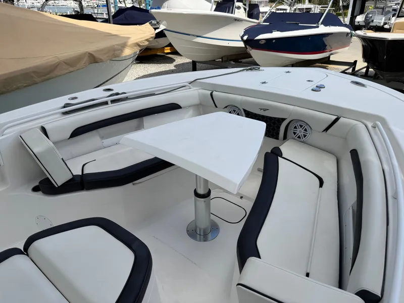 Slide: The Image of The image shows the cockpit of a 2021 Tidewater 272 CC Adventure boat with white seating. - 44