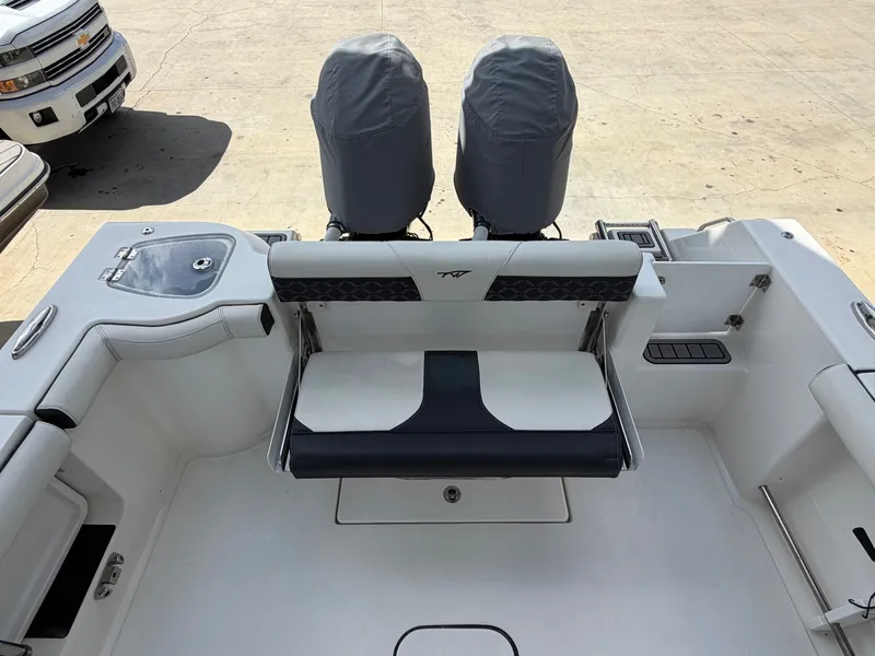 Slide: The Image of The image shows the stern of a 2021 Tidewater 272 CC Adventure boat with two engines. - 14