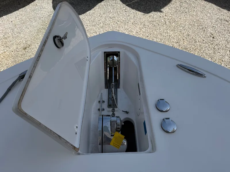 Slide: The Image of An open anchor compartment on a boat with visible windlass and chain. - 37