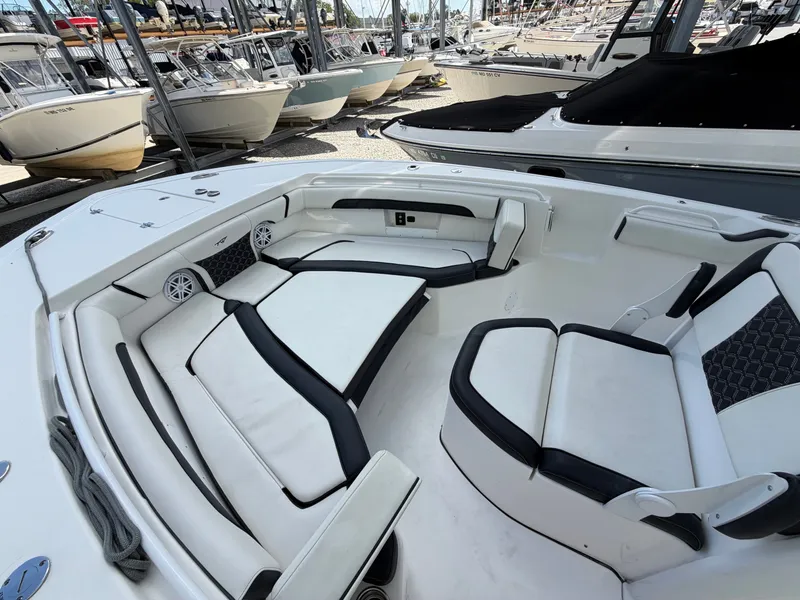 Slide: The Image of The image shows the cockpit of a 2021 Tidewater 272 CC Adventure with white and black upholstery. - 46
