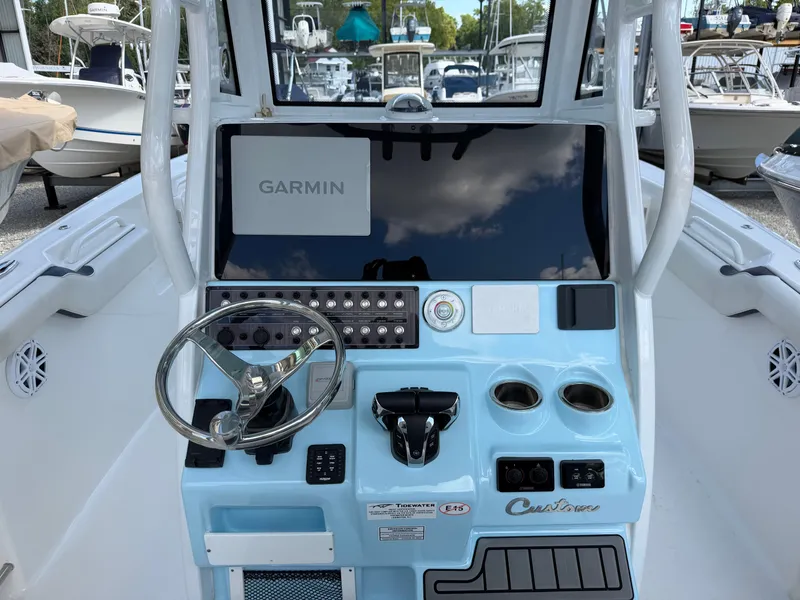 Slide: The Image of The image shows the helm of a 2021 Tidewater 272 CC Adventure boat with Garmin navigation. - 24