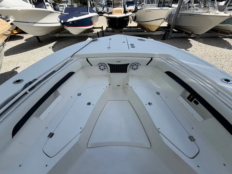 Slide: The Image of The image shows the bow area of a 2021 Tidewater 272 CC Adventure boat with seating and speakers. - 35
