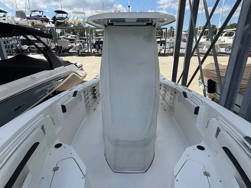 Slide: The Image of The image shows the cockpit of a 2021 Tidewater 272 CC Adventure boat docked at a marina. - 20