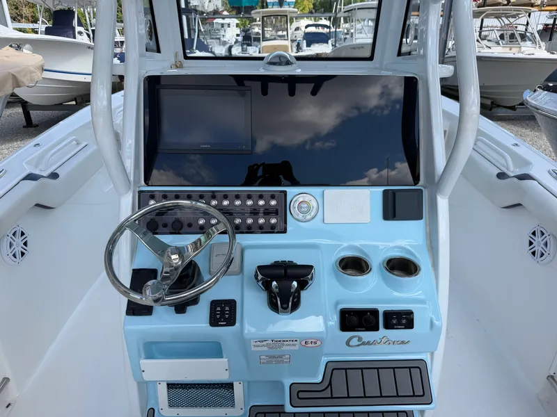 Slide: The Image of The image shows the helm of a 2021 Tidewater 272 CC Adventure boat with modern instruments. - 23