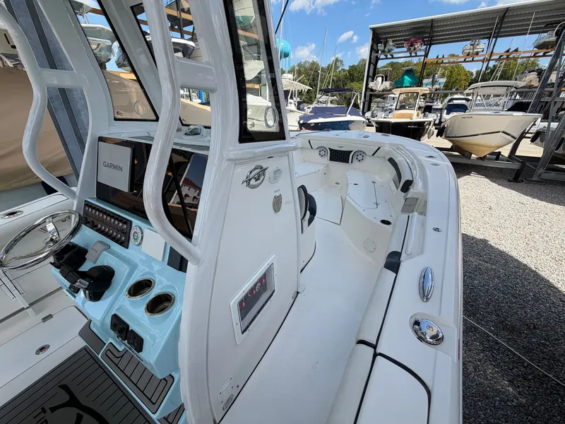 Slide: The Image of The image shows the cockpit of a 2021 Tidewater 272 CC Adventure boat with modern features. - 28
