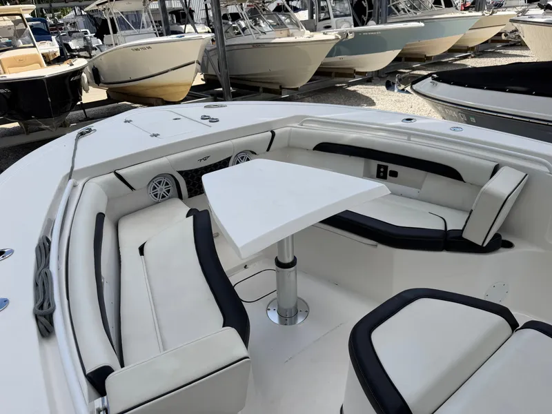 Slide: The Image of The image shows the cockpit of a 2021 Tidewater 272 CC Adventure boat with white upholstery. - 43