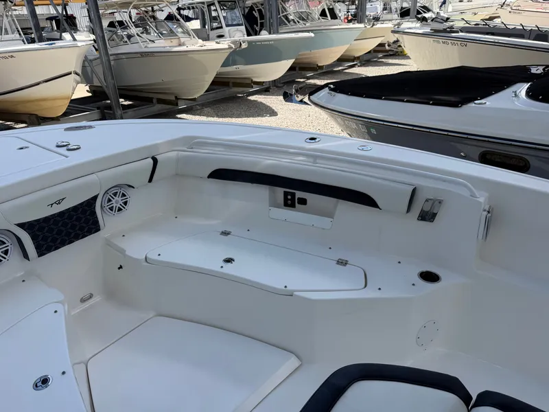 Slide: The Image of The image shows the cockpit of a 2021 Tidewater 272 CC Adventure boat, surrounded by other boats. - 31