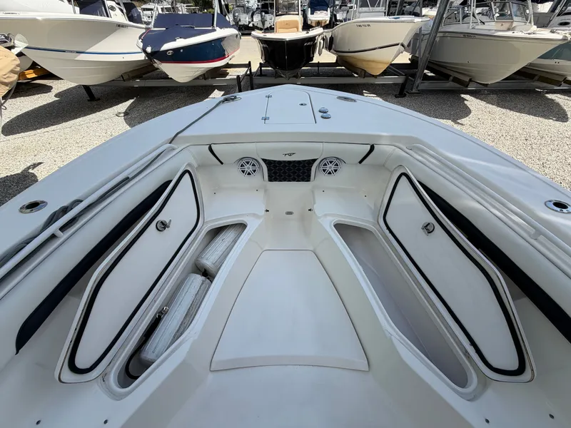 Slide: The Image of The image shows the bow area of a 2021 Tidewater 272 CC Adventure boat with seating and speakers. - 34