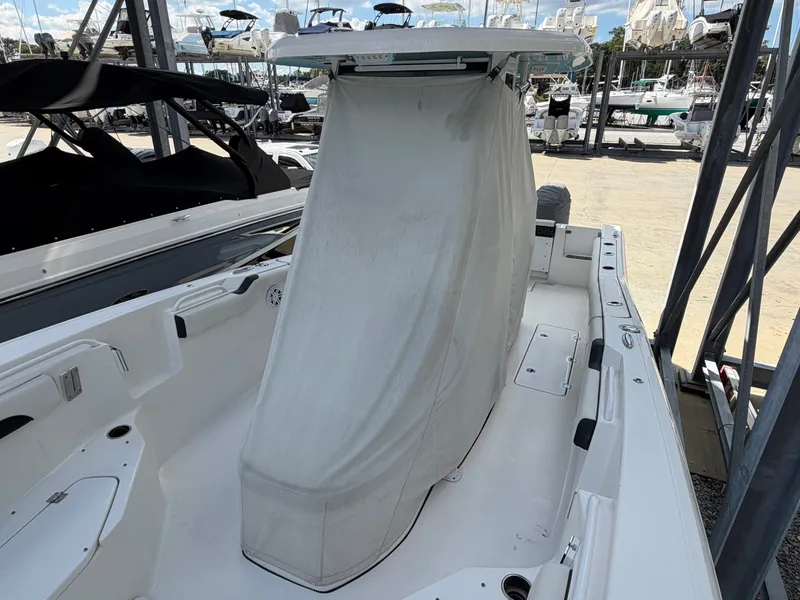 Slide: The Image of A 2021 Tidewater 272 CC Adventure boat with a covered helm station at the marina. - 22
