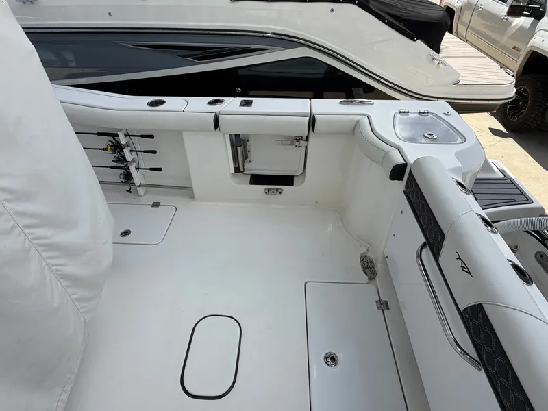 Slide: The Image of The image shows the cockpit of a 2021 Tidewater 272 CC Adventure boat with fishing rod holders. - 15