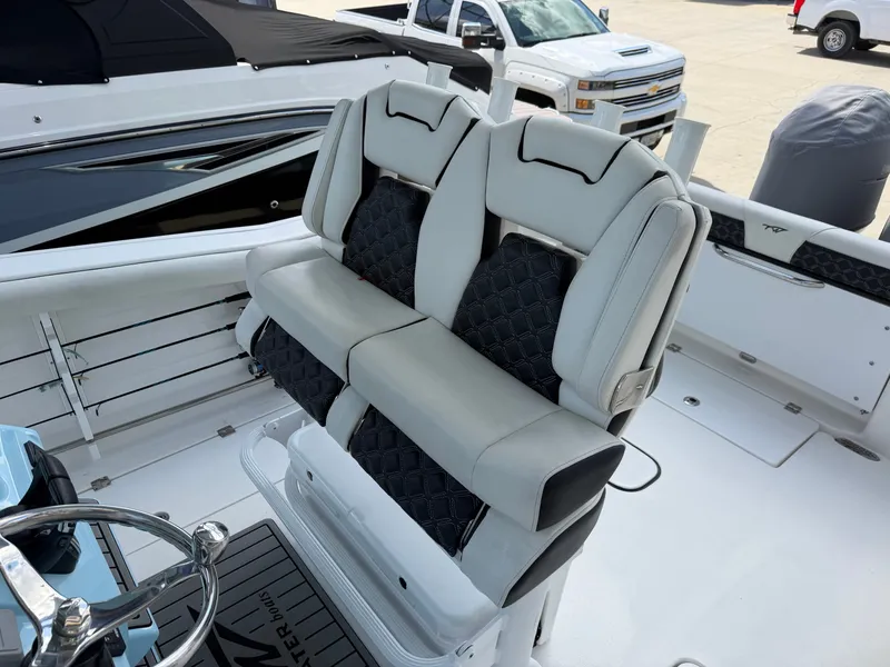 Slide: The Image of The 2021 Tidewater 272 CC Adventure features cushioned seats with a black and gray design. - 26