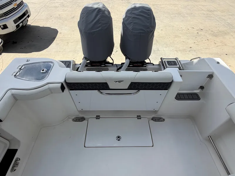 Slide: The Image of The image shows the cockpit of a 2021 Tidewater 272 CC Adventure boat with two cushioned seats. - 13