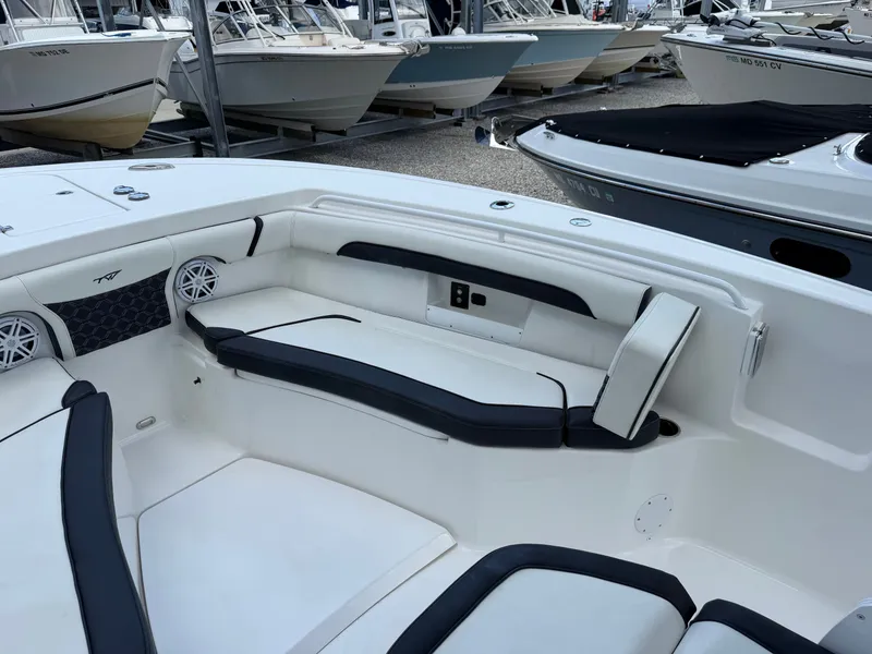 Slide: The Image of The image shows the cockpit of a 2021 Tidewater 272 CC Adventure boat with white and black upholstery. - 39