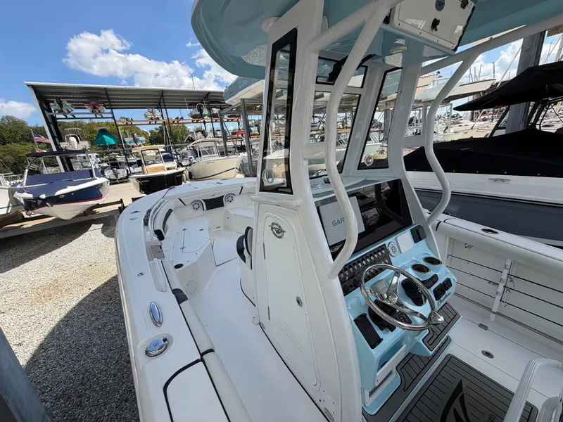 Slide: The Image of The image shows a 2021 Tidewater 272 CC Adventure boat with a modern helm station. - 29
