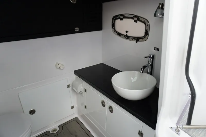 Slide: The Image of Modern bathroom interior of 2027 Monterey Elite 30 OB boat, featuring sleek sink and fixtures. - 25