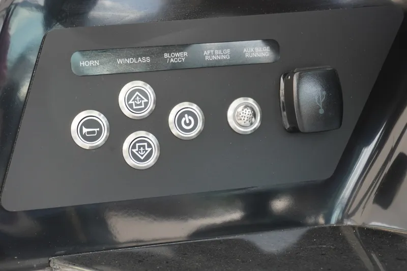 Slide: The Image of Control panel of 2027 Monterey Elite 30 OB boat with labeled buttons and switches. - 18