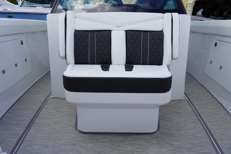 Slide: The Image of Luxury seating on 2027 Monterey Elite 30 OB boat, featuring elegant black and white upholstery. - 23