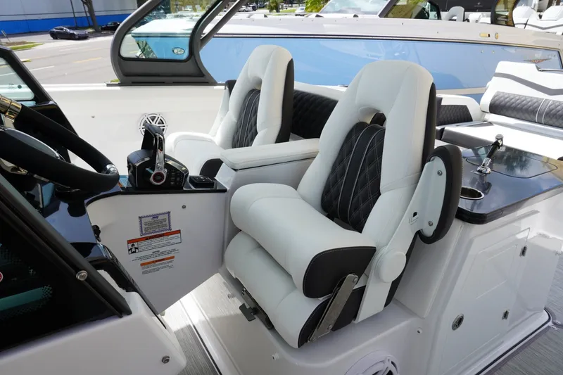 Slide: The Image of Luxurious interior of 2027 Monterey Elite 30 OB boat with plush seating and modern controls. - 14