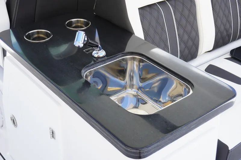 Slide: The Image of Luxury sink and cup holders on 2027 Monterey Elite 30 OB boat interior. - 13