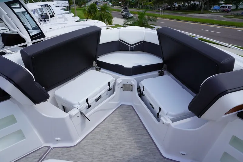 Slide: The Image of 2027 Monterey Elite 30 OB boat interior with cushioned seating and storage compartments. - 21