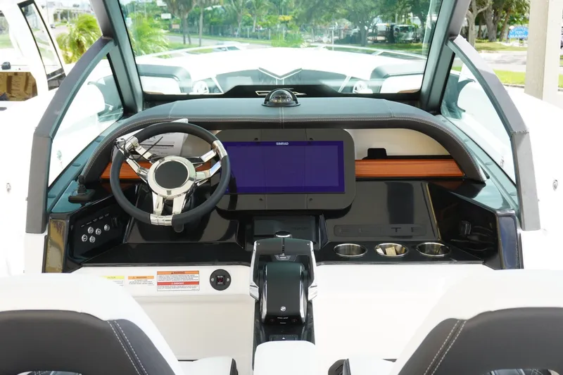 Slide: The Image of Cockpit of 2027 Monterey Elite 30 OB boat with modern steering and touchscreen display. - 16