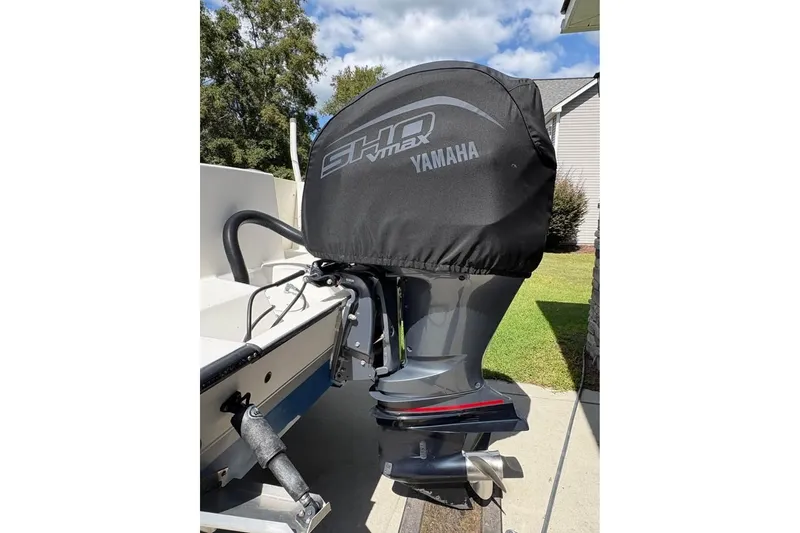 Slide: The Image of Yamaha outboard motor on 2003 Contender 23 Open boat, covered with protective cover. - 4