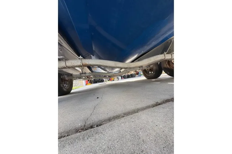 Slide: The Image of Underneath view of a 2003 Contender 23 Open boat on a trailer. - 17